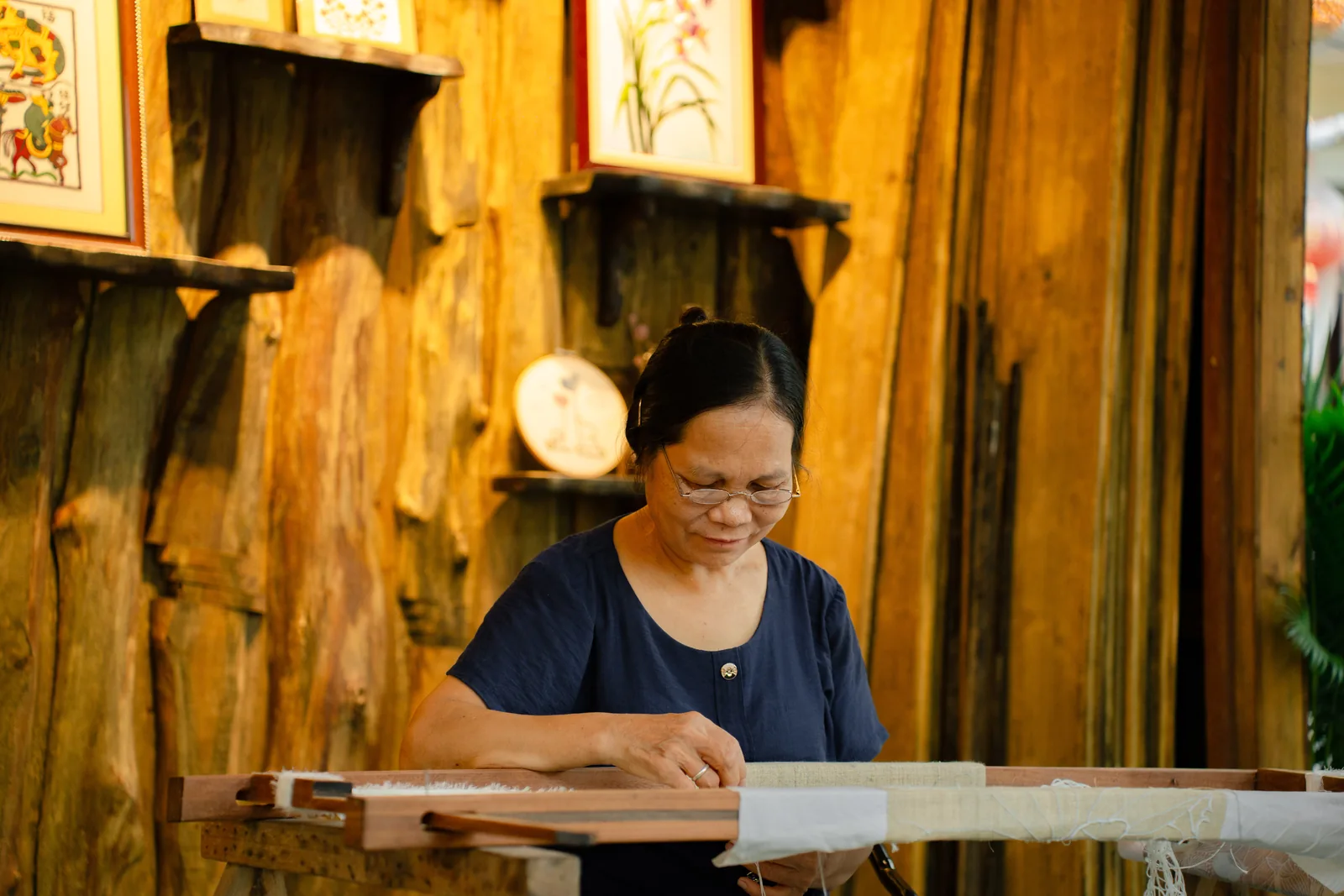 Dinh Thi Nguyen doing traditional hand embroidery in Van Lam Village