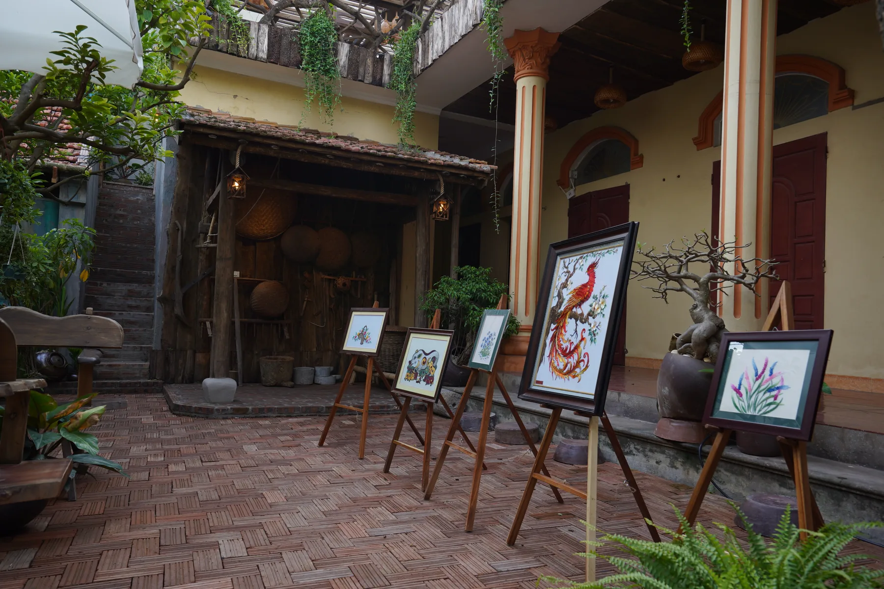 Traditional hand embroidered artworks displayed in a family courtyard in Van Lam Village, Tam Coc
