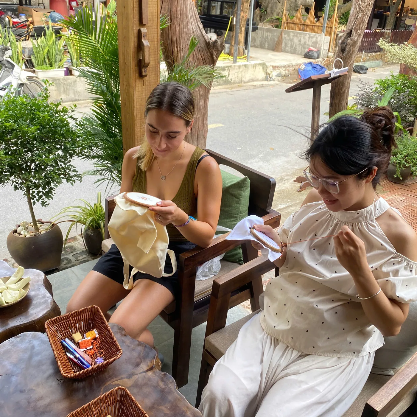 Travelers learning hand embroidery together in a family home in Van Lam Village, Tam Coc