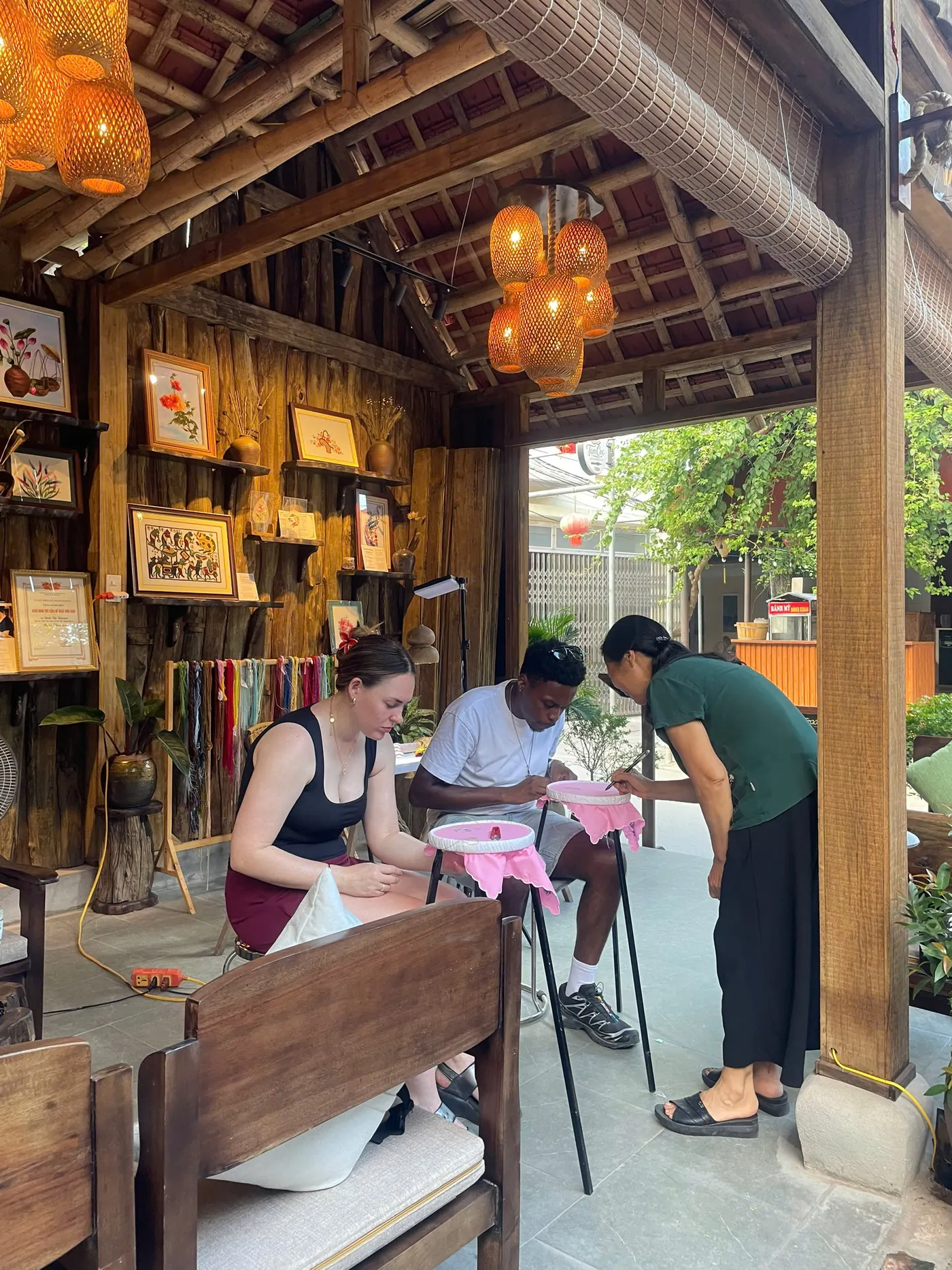Guests learning traditional hand embroidery and choosing thread colors in Tam Coc